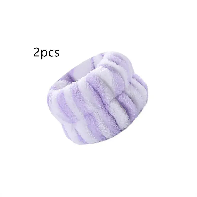 Soft, striped lavender headband or hair wrap made of plush fabric.