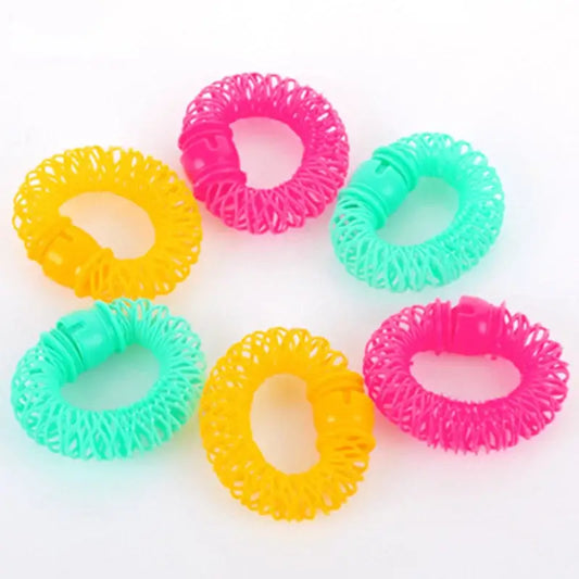 Colorful plastic spiral hair ties in yellow, pink, and green.