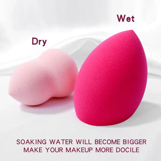 Teardrop-shaped makeup sponges in light pink and bright pink colors.