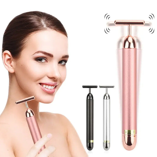 Facial massage tool with vibrating T-bar head in rose gold color.