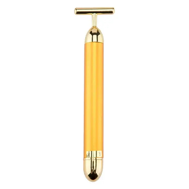 Golden facial massage tool with a T-shaped handle and cylindrical body.