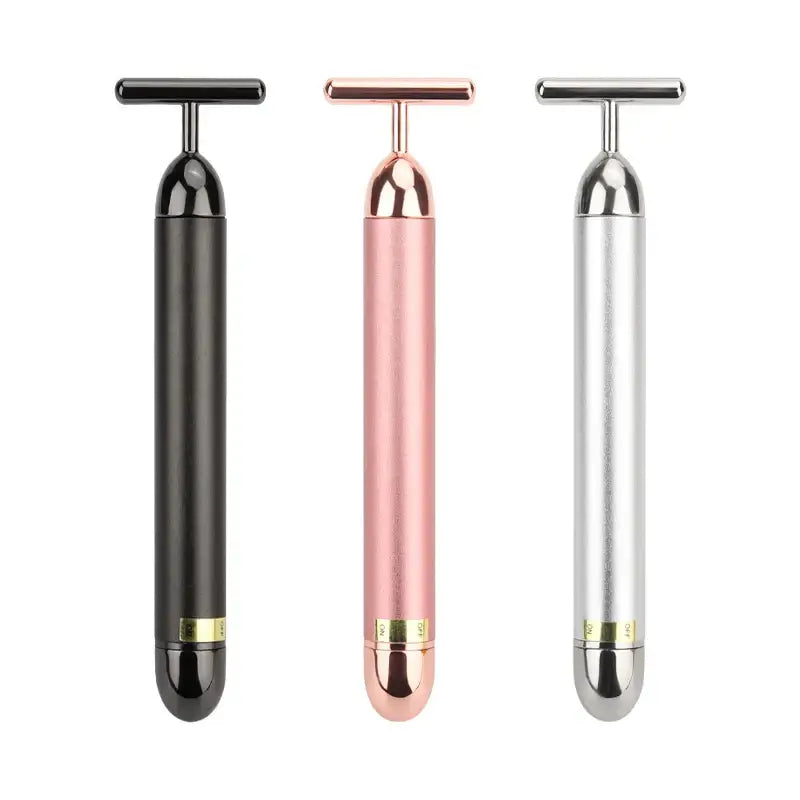 Sleek, cylindrical facial massage tools in black, rose gold, and silver colors with T-shaped handles.