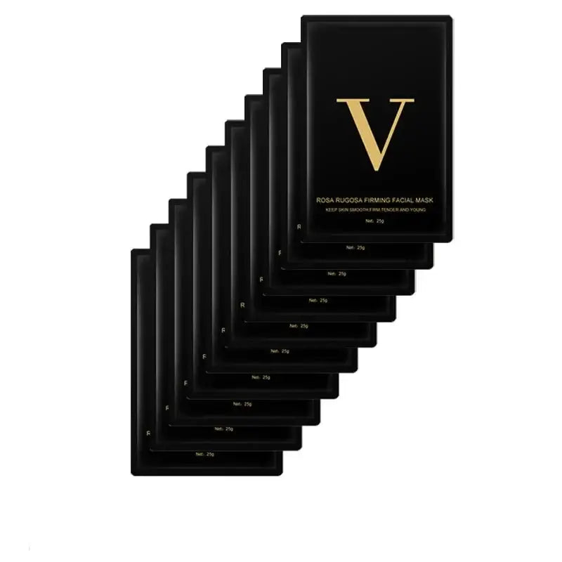 Stack of black facial masks with gold ’V’ lettering on the top packet.