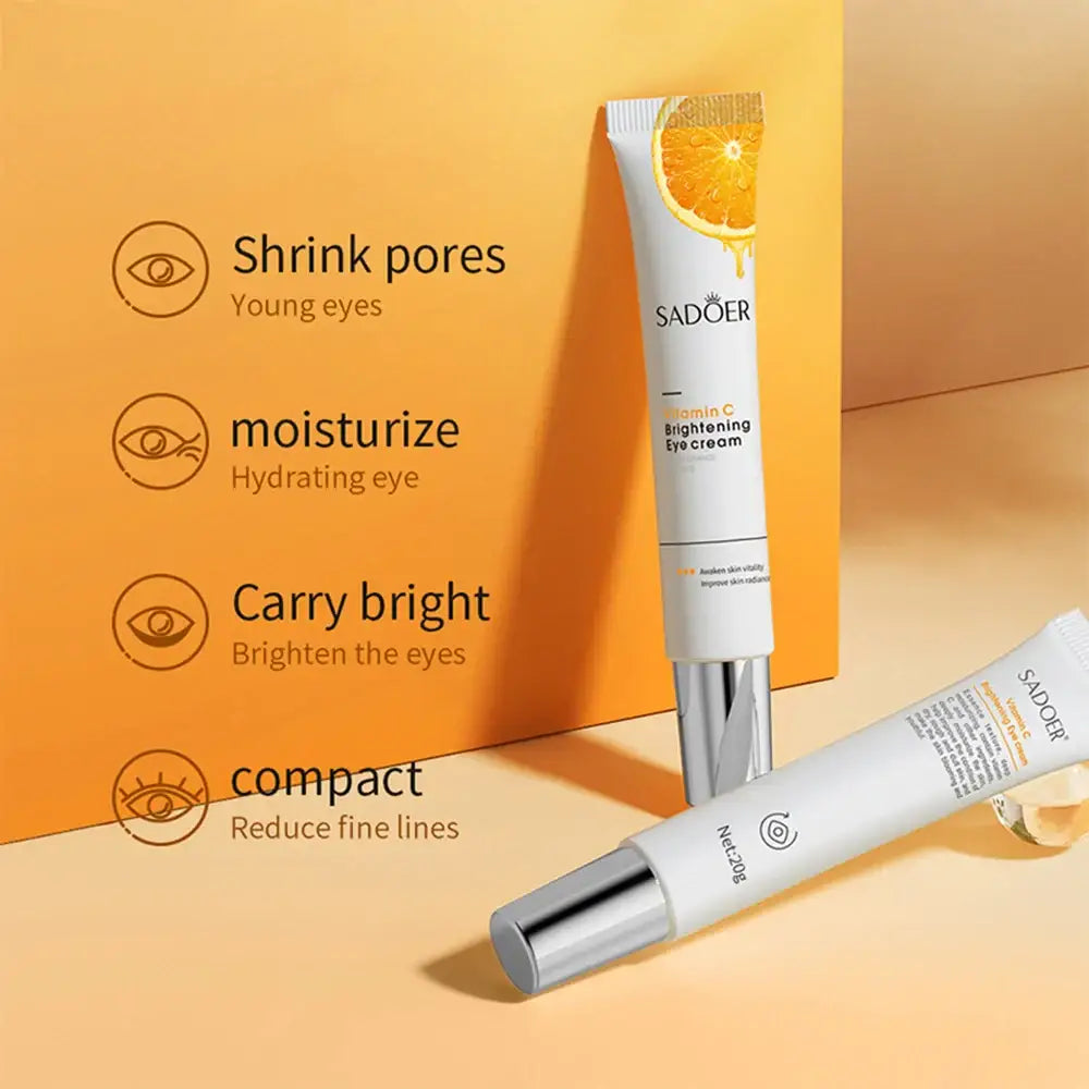 Eye cream product tube with orange slice decoration and listed skincare benefits.