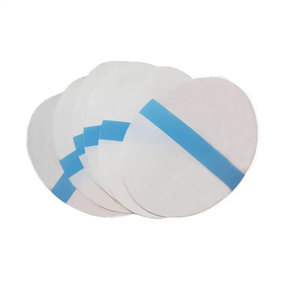 White circular filters or pads with blue adhesive strips.