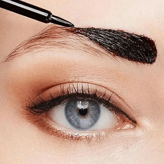 Eyebrow being filled in with a makeup brush.