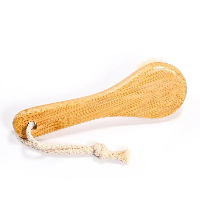 Wooden spoon or spatula with a rope handle attached.