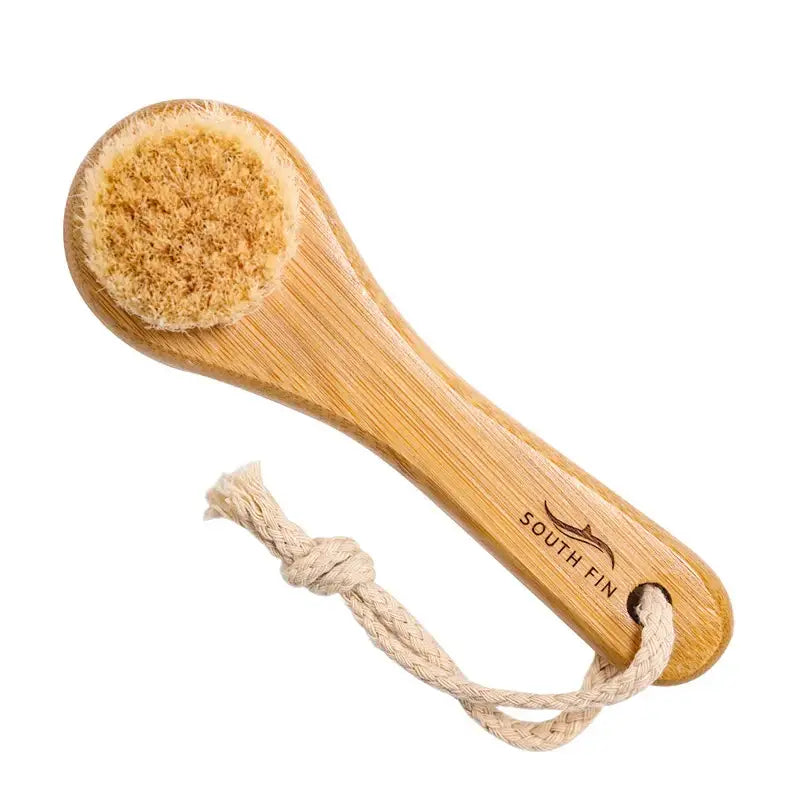 Wooden-handled body brush with natural bristles and a rope loop for hanging.