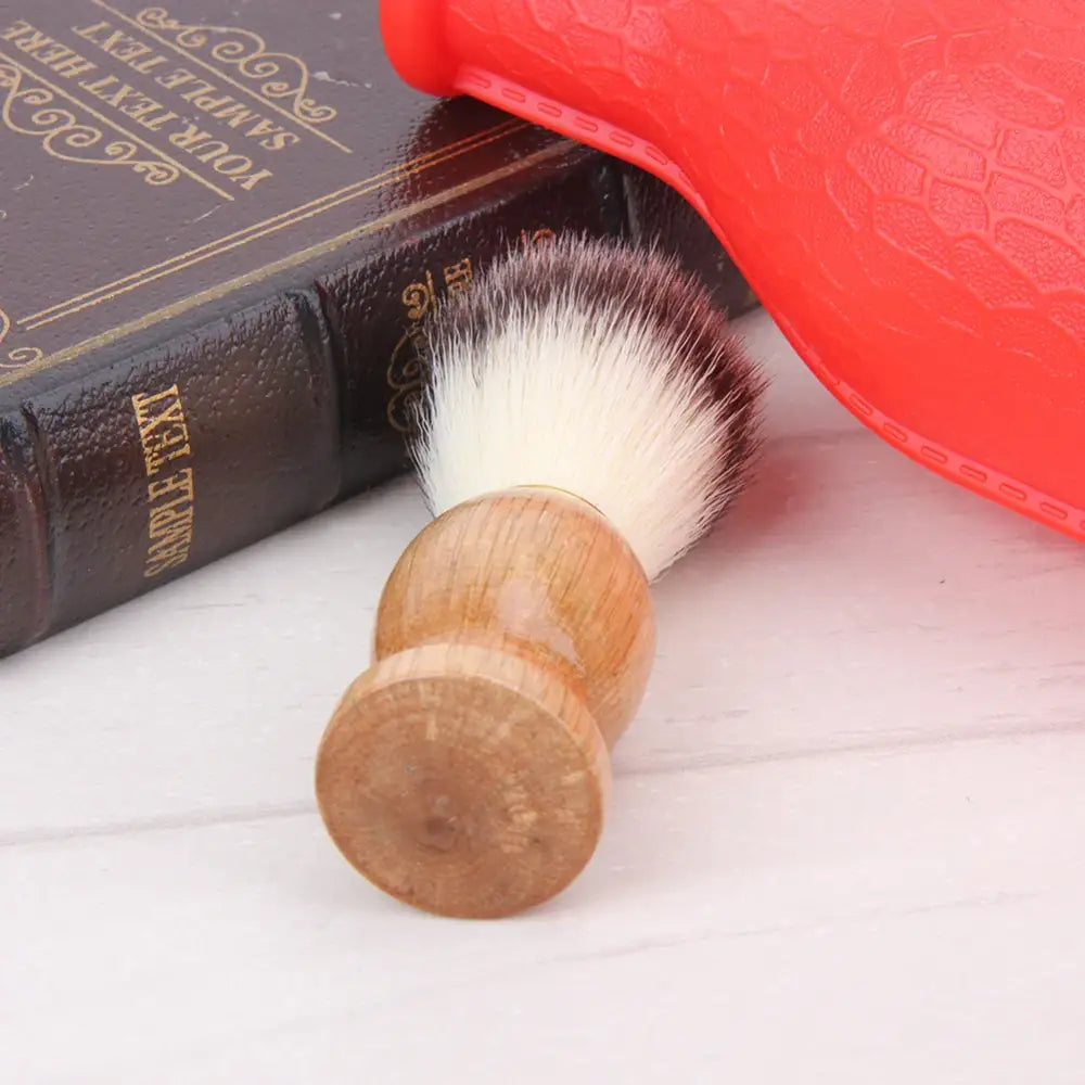 Shaving brush with a wooden handle and white bristles.