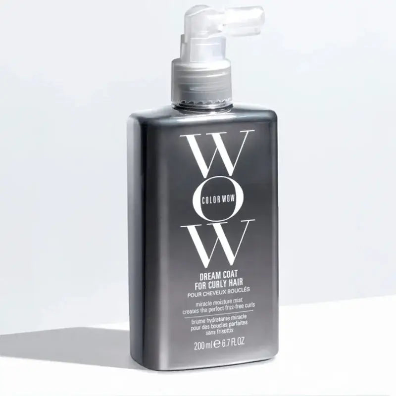 Sleek gray bottle of ’WOW’ hair cream for curly hair with a pump dispenser.