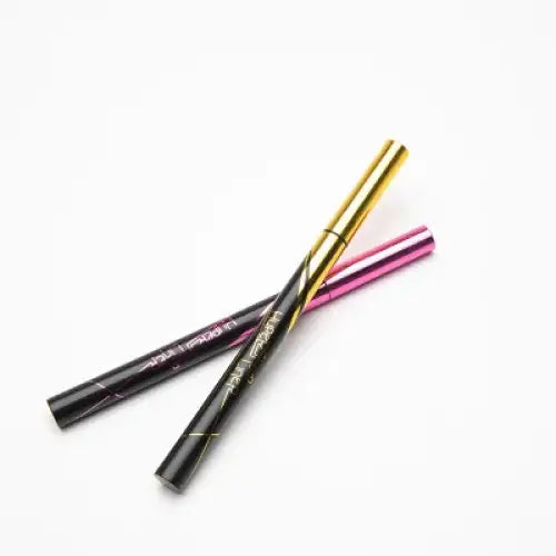 Three eyeliner pencils in gold, pink, and black colors.